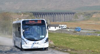 A DalesBus pictured with Ribblehead Viaduct in the background