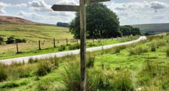 A Pennine Way sign showing the distance to Top Withens and Widdor Road,