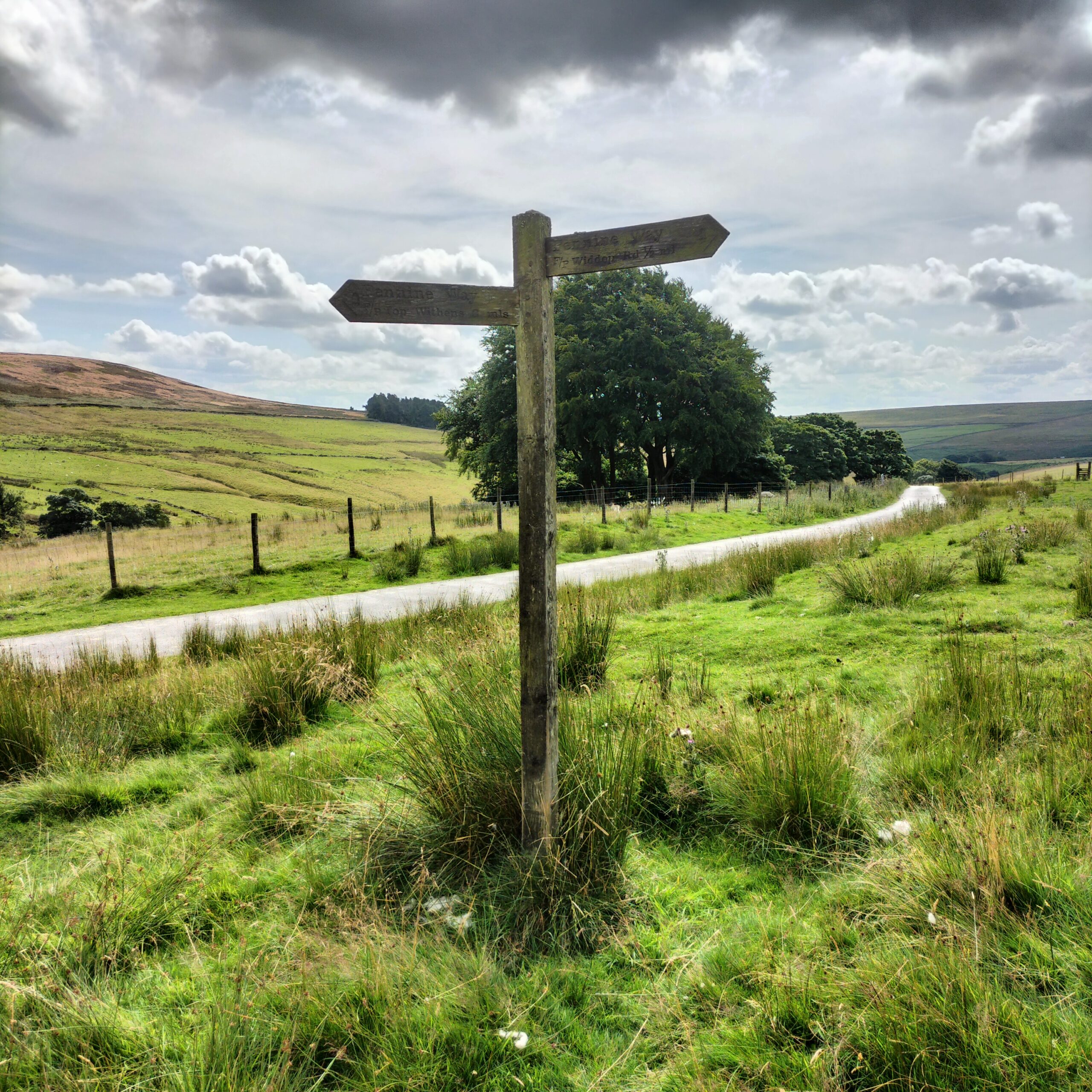 A Pennine Way sign showing the distance to Top Withens and Widdor Road,
